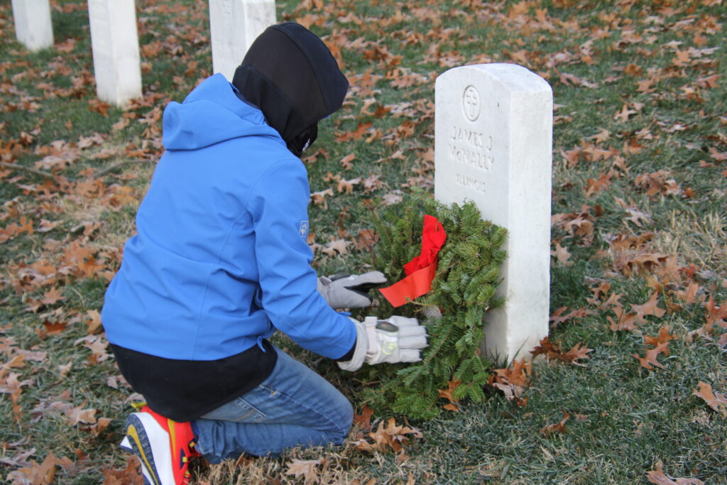 boy placing wreath